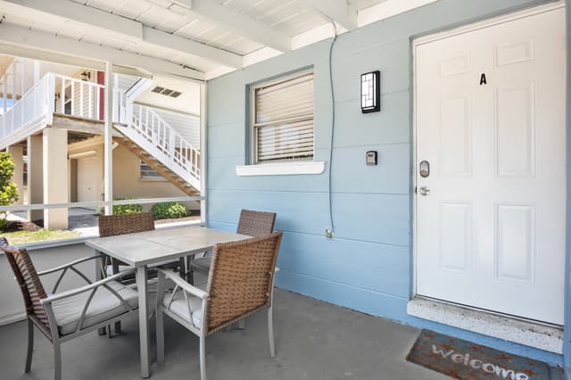 Screened-in lanai with outdoor dining table.