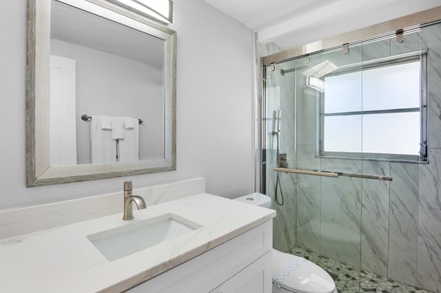 Updated bathroom with modern finishes and walk-in shower.