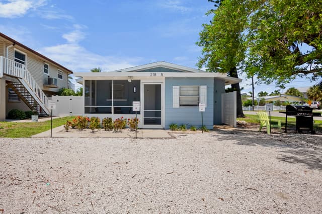 Exterior view of the home with screened lanai and dedicated parking.