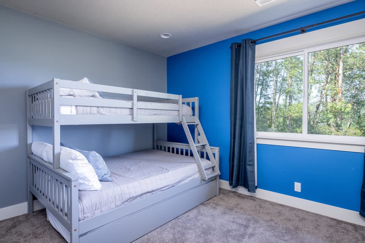 Kids will love the bunk room with a twin/full bunk bed + trundle.