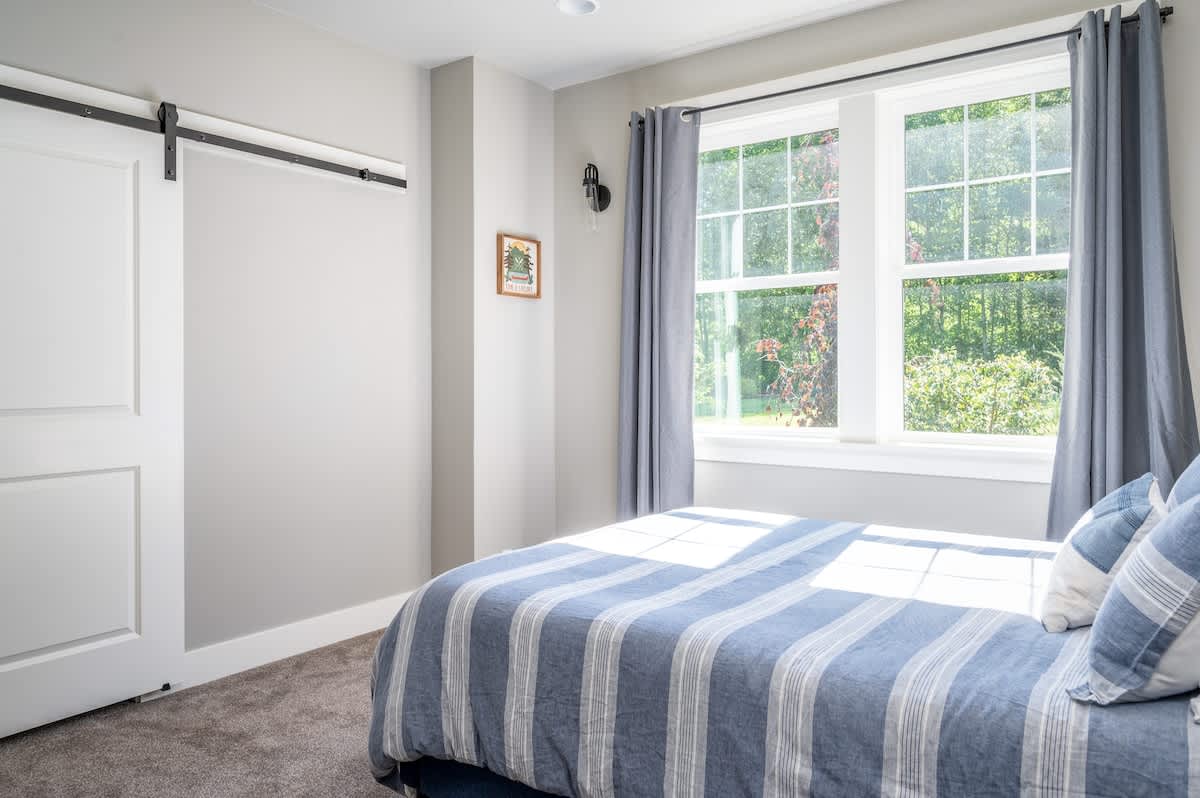 A oversized walk-in closet is just behind the barn-door. A small pop-up crib is available for littles.