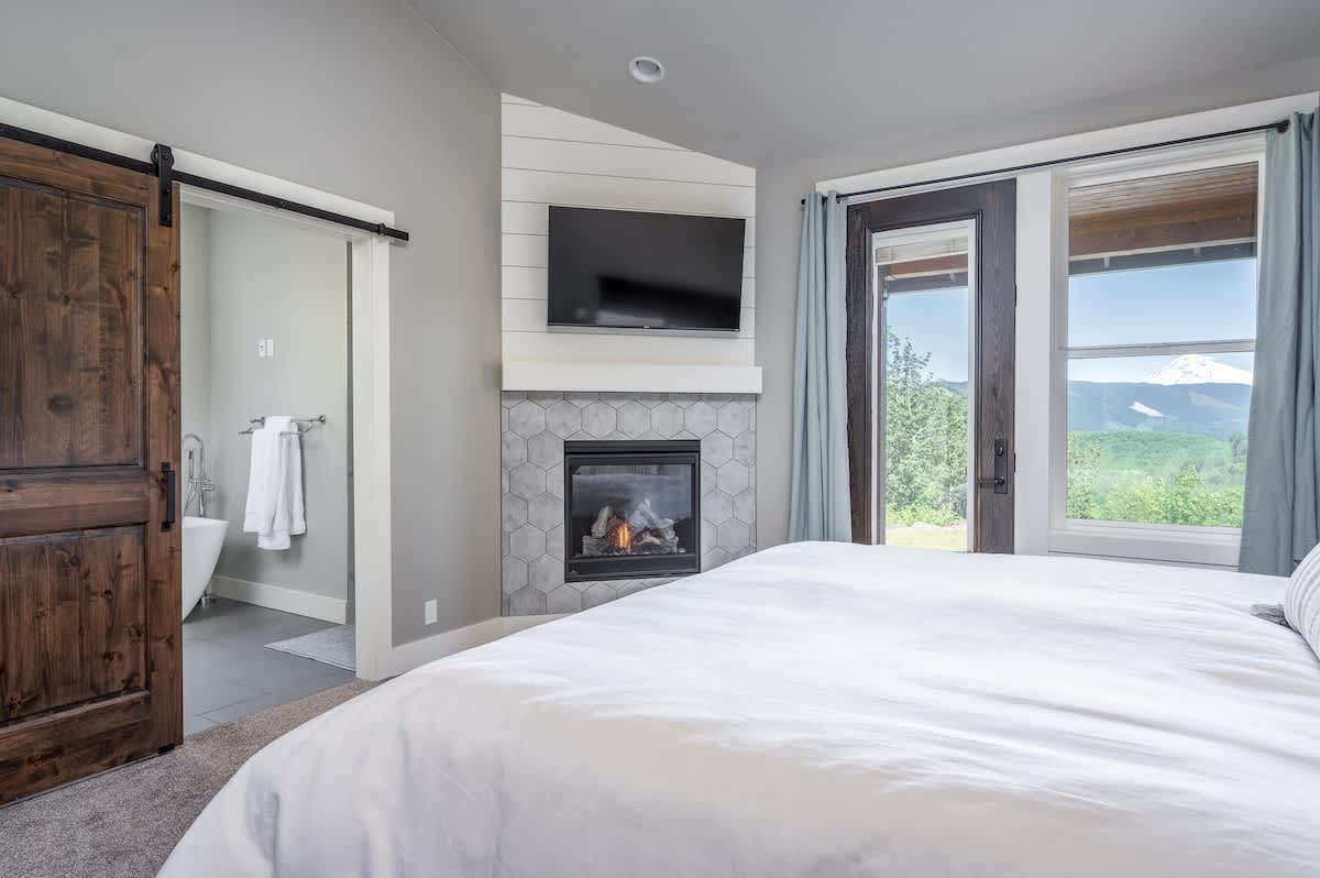 Retreat to your private oasis with in-room TV, electric fireplace, mountain views, and en-suite bathroom.