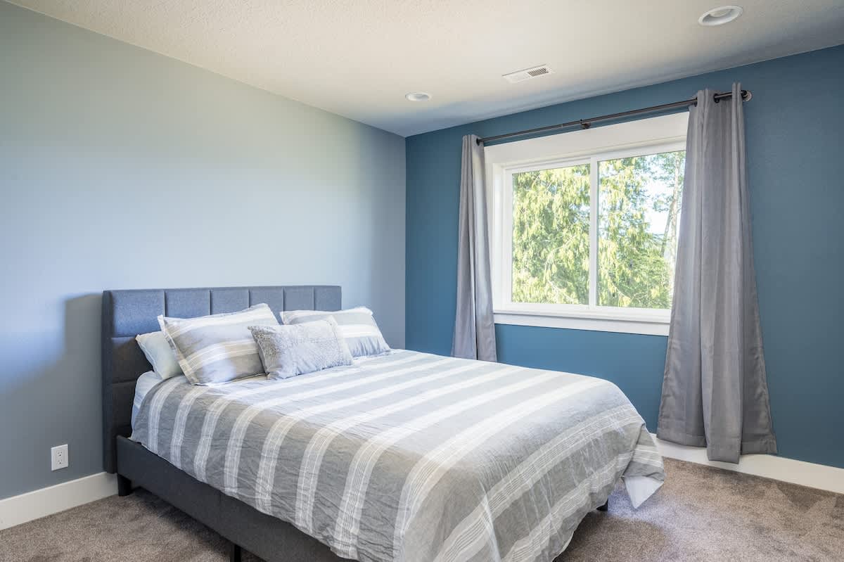 The second upstairs guest room has a queen bed and view of Mt. Hood. The closet also has two twin air mattresses for extra guests.