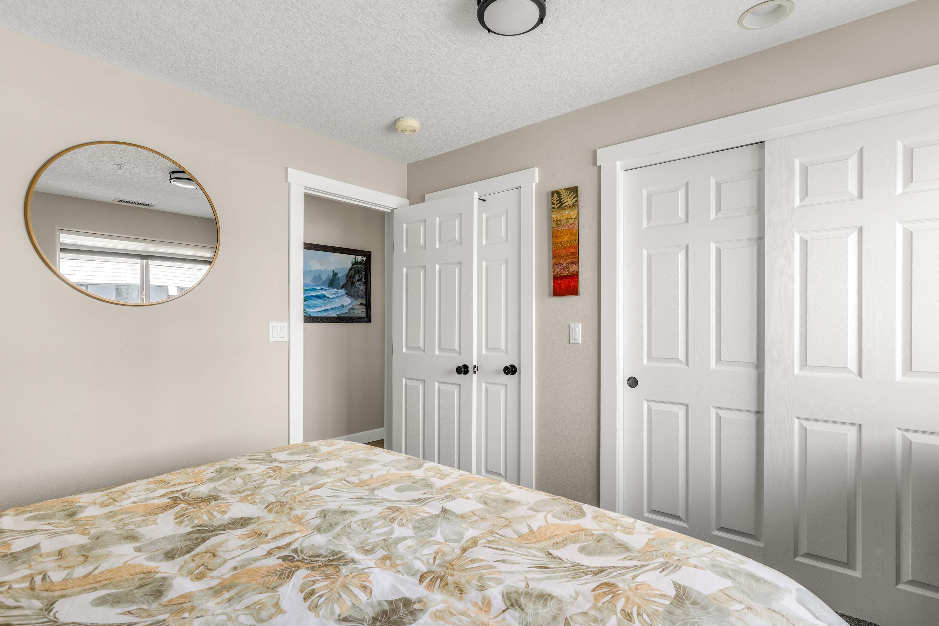 Cozy secondary bedroom featuring a king bed, plush bedding, and a bright, inviting atmosphere.