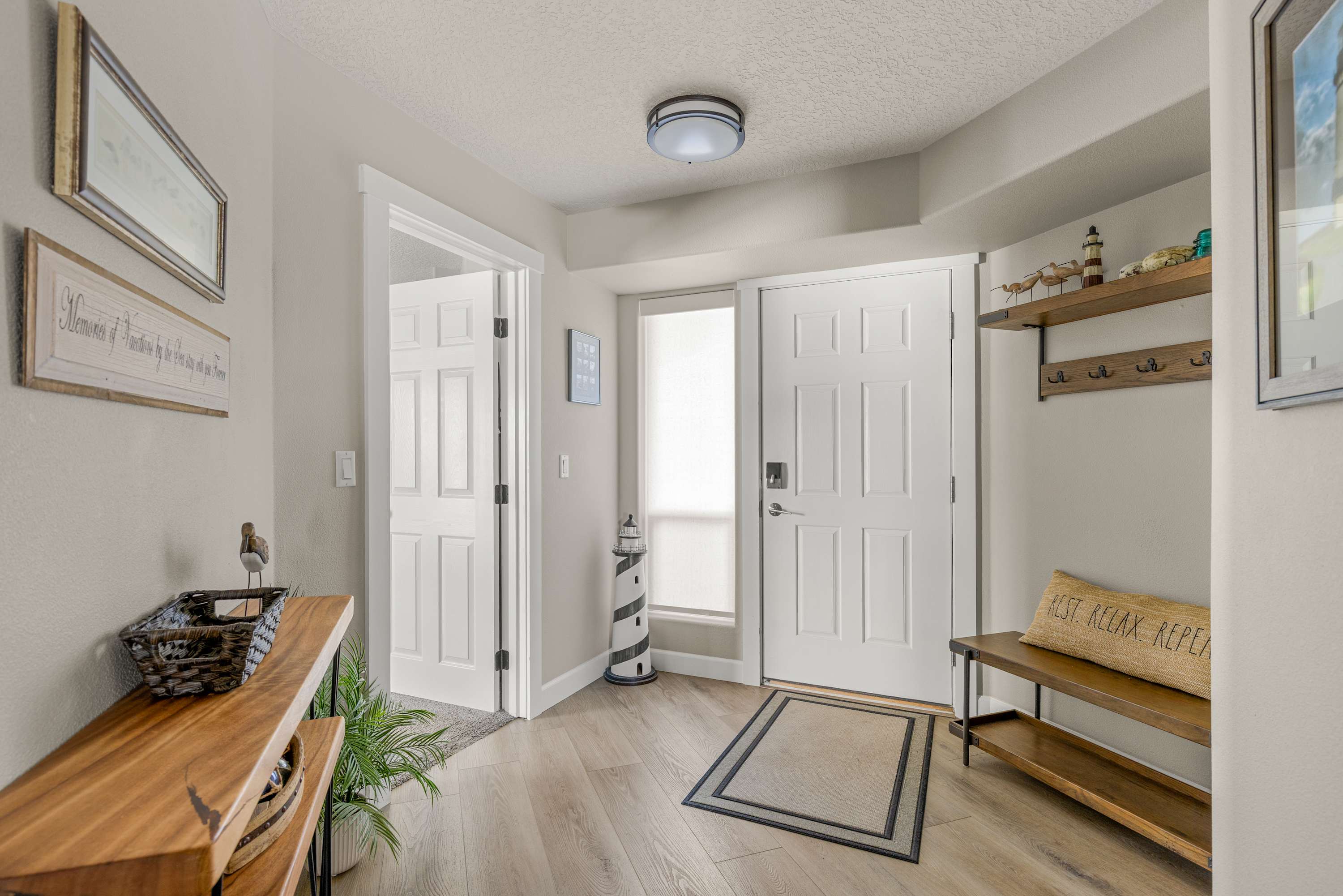 Clean and spacious entry with coastal décor, secure access, and convenient layout designed for comfort and easy check-in.