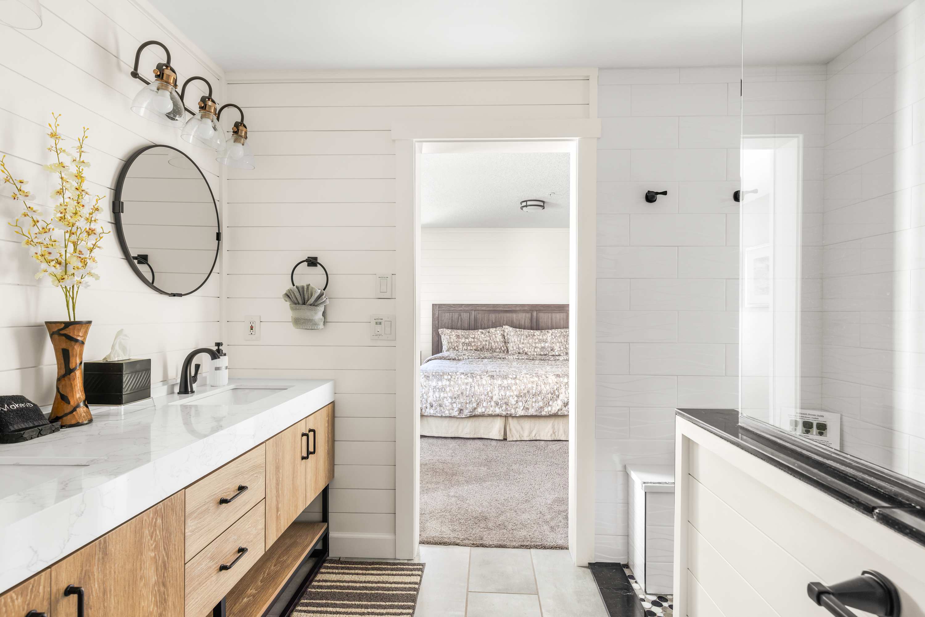 Modern ensuite bathroom with dual vanity, walk-in shower, and clean coastal design.