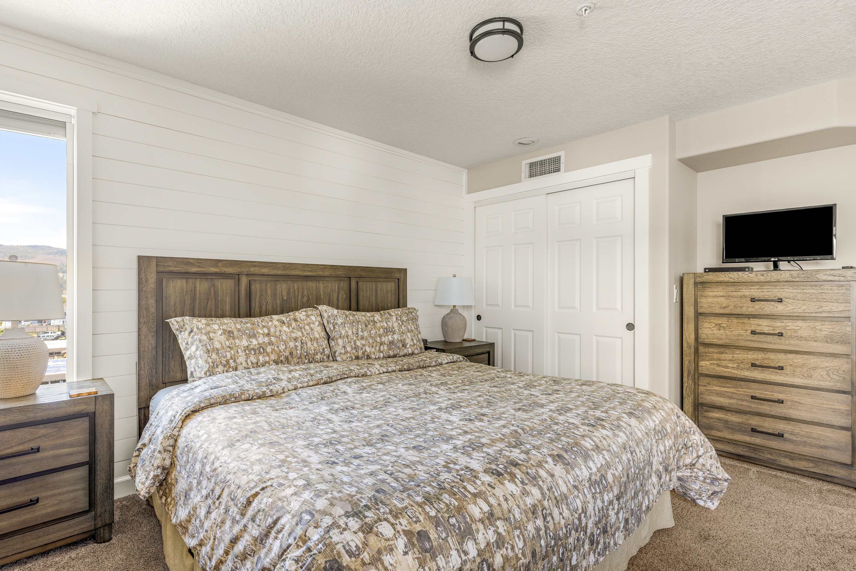 Comfortable king bedroom with stylish furnishings, soft linens, and a peaceful setting for restful nights.