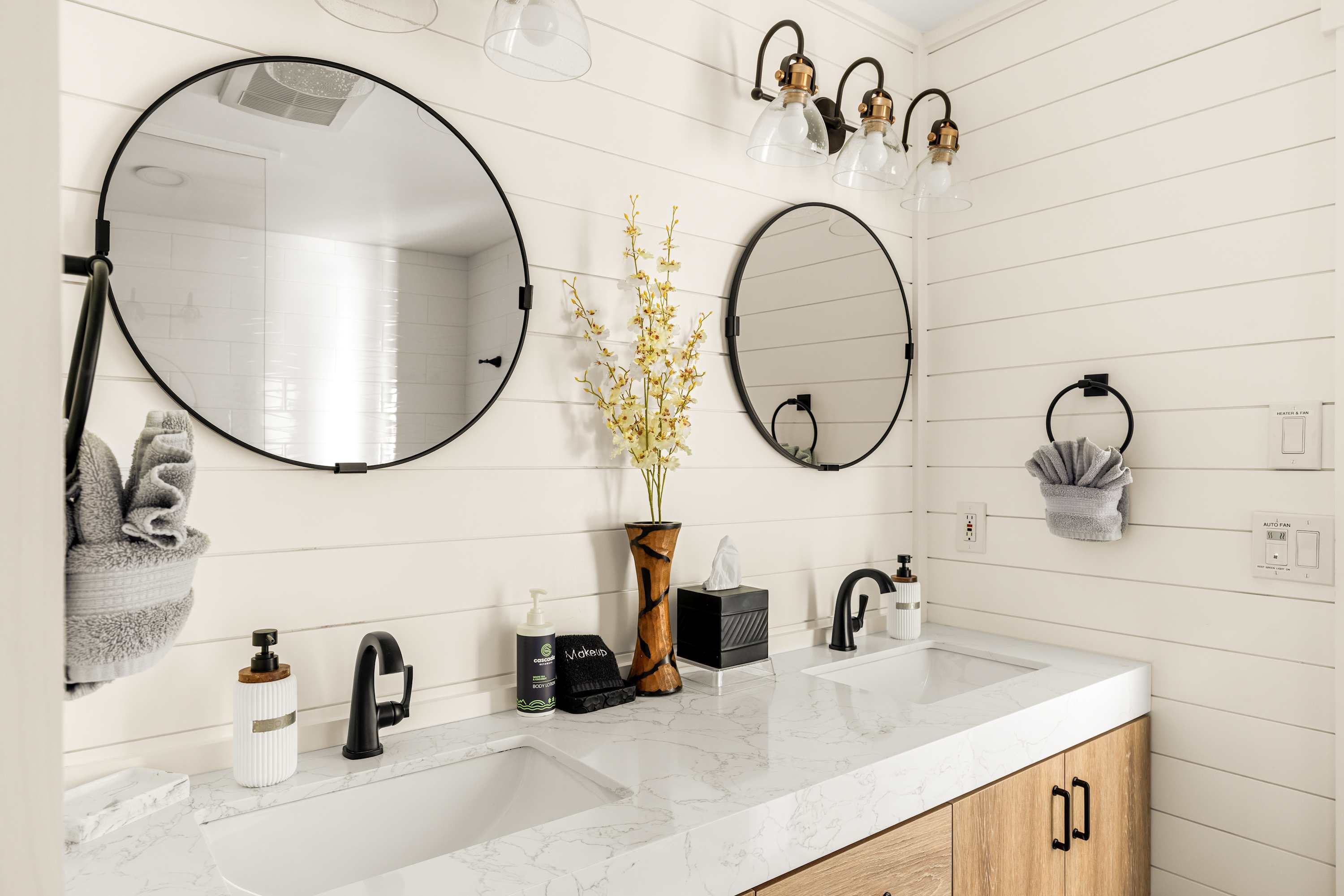 Dual vanity with modern fixtures, ample counter space, and stylish mirrors for added convenience.