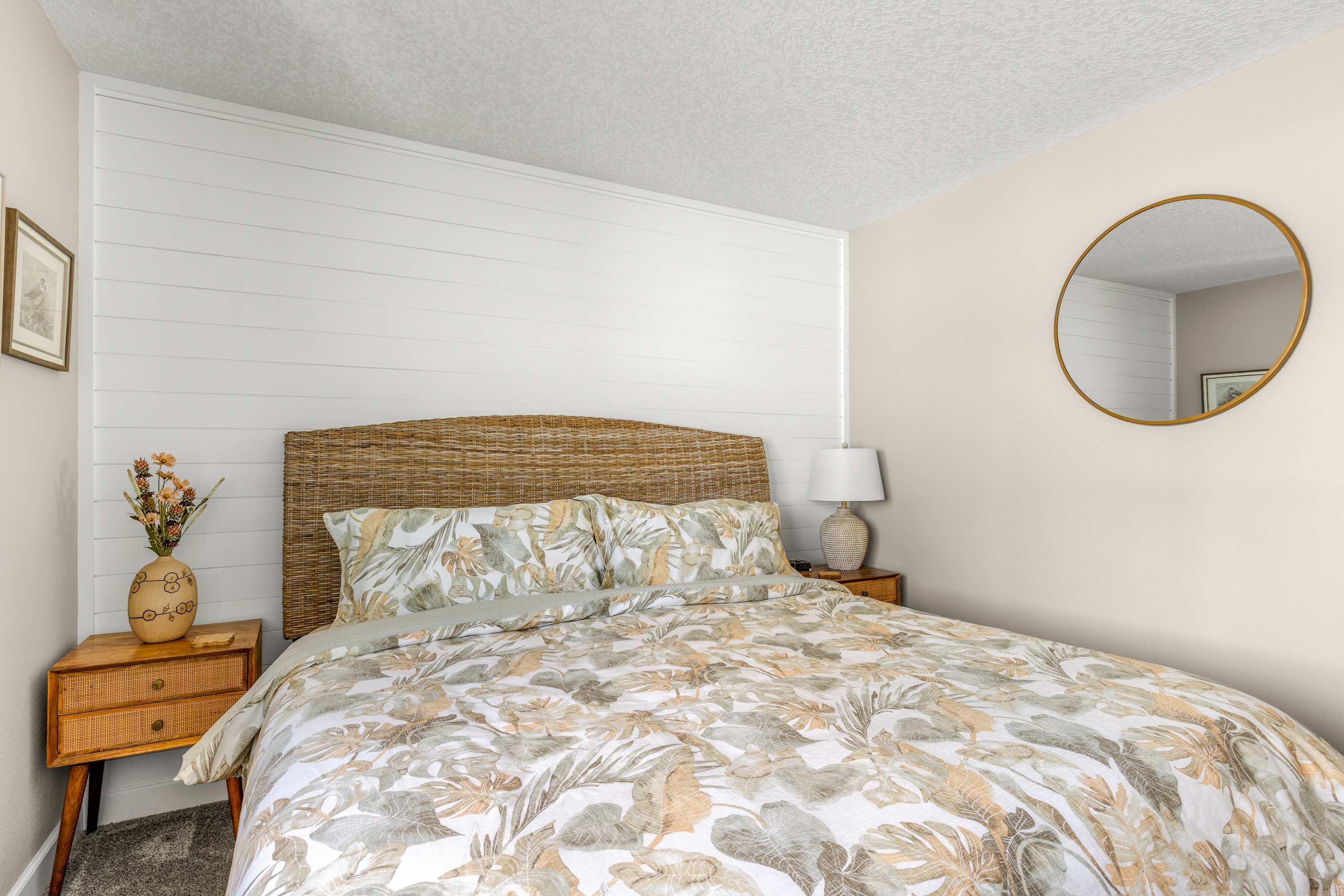 Sink into this cozy king bed with soft linens and warm textures—perfect for restful nights.
