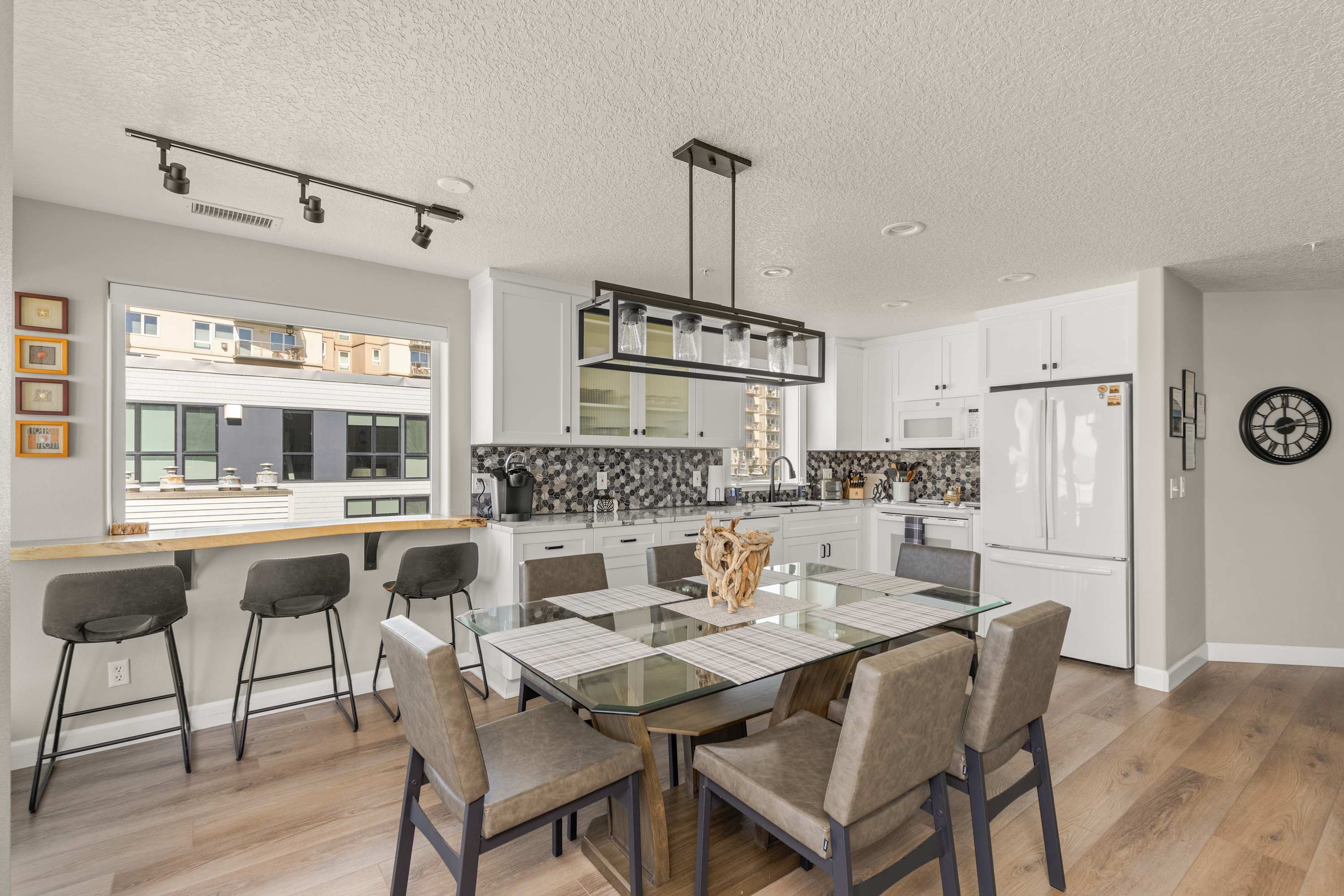 Fully equipped kitchen with breakfast bar and dining area, designed for both convenience and style.