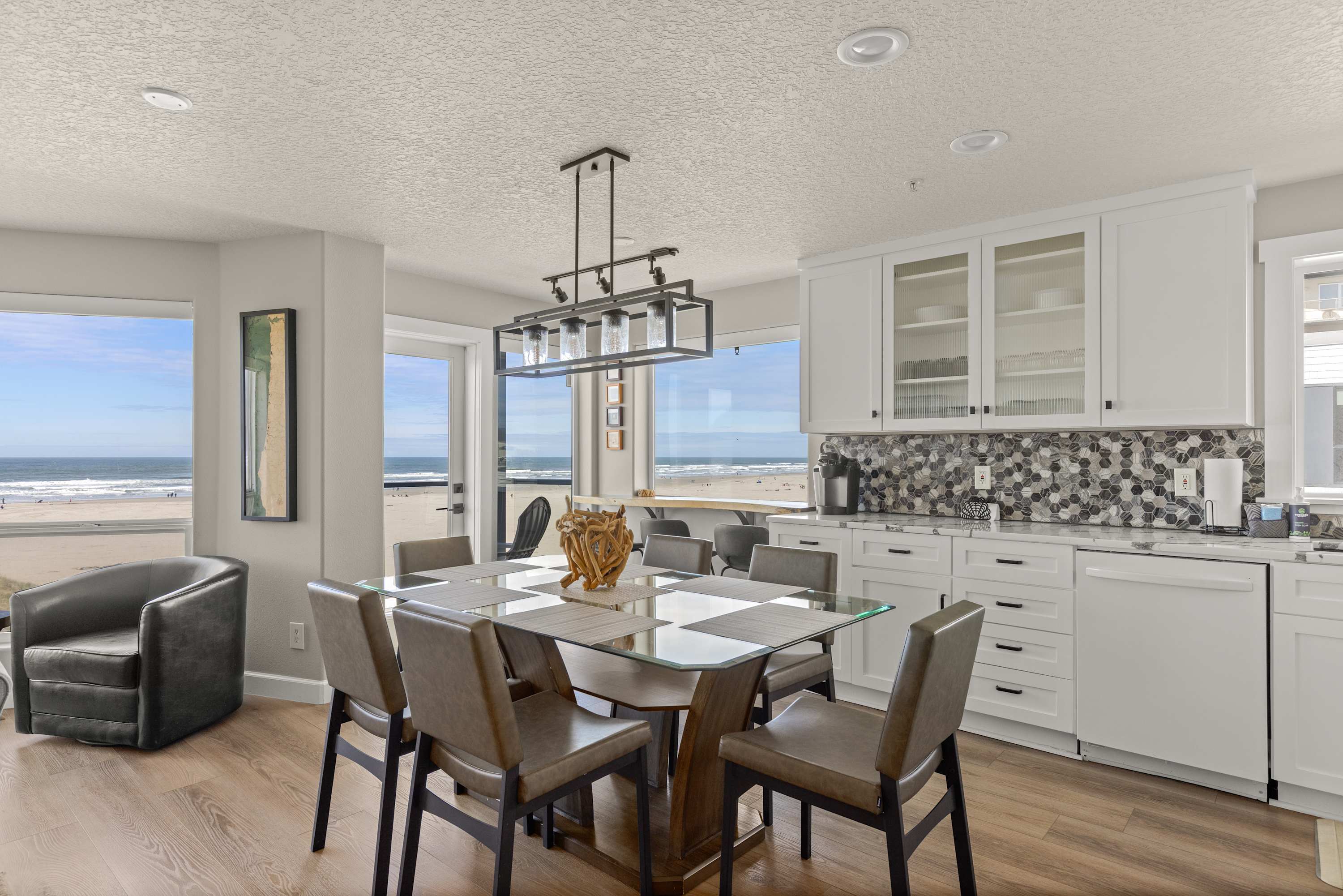 Enjoy meals with stunning ocean views in this open dining area next to a fully equipped modern kitchen.
