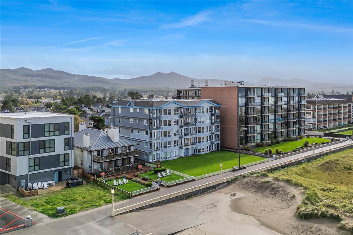 Oceanfront building with manicured lawn, direct Promenade access, and stunning Pacific Ocean views.