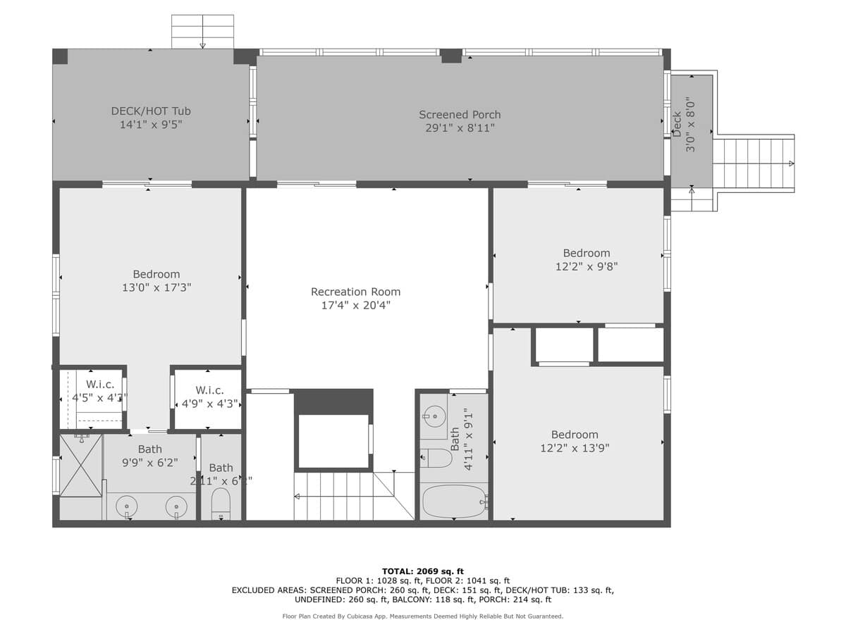 A comprehensive floor plan of the lower level, illustrating the arrangement of three bedrooms, a recreation room, multiple bathrooms, and an outdoor deck with a hot tub. Walk-in closets are also visible within the bedroom layouts.