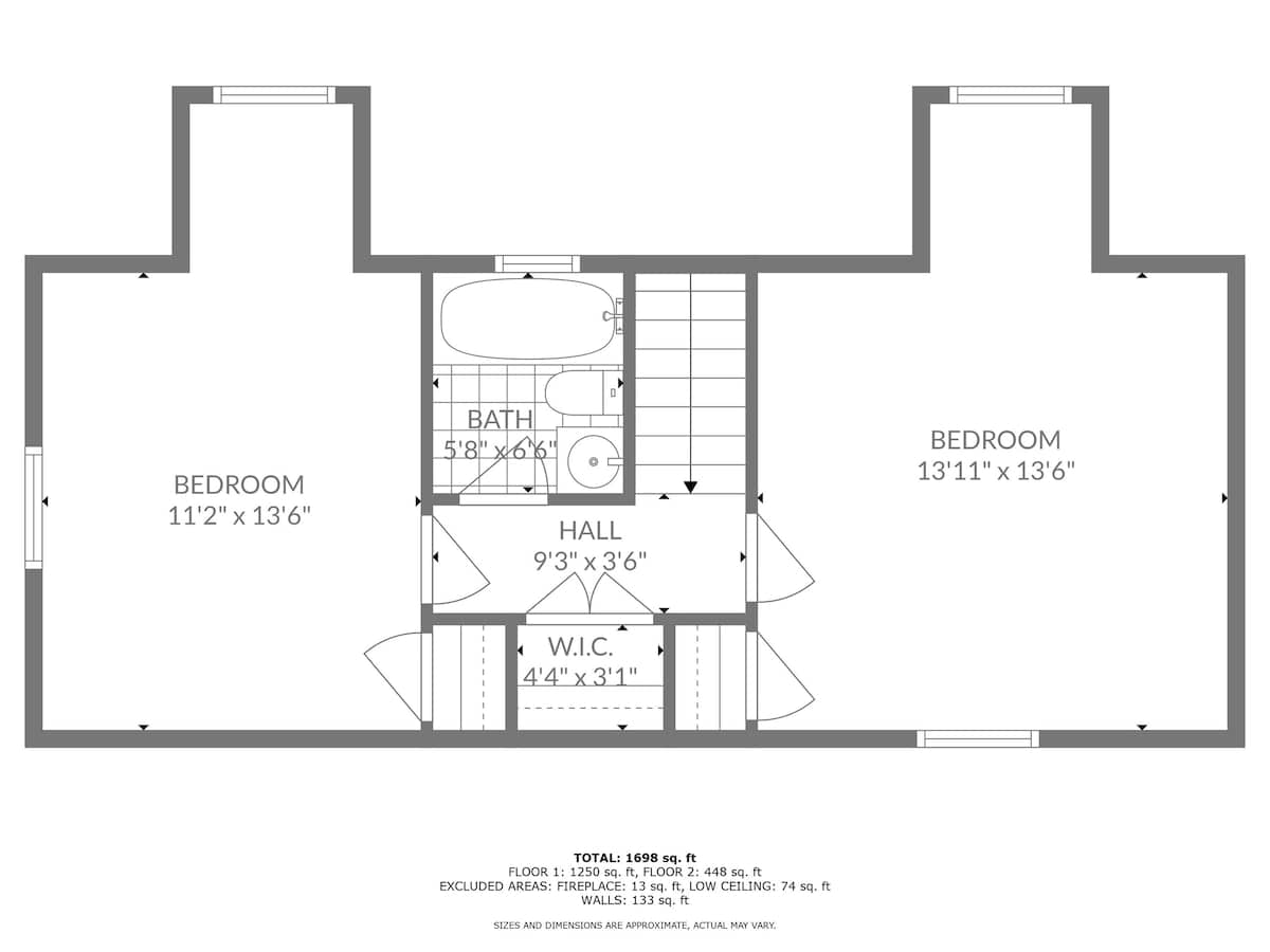 A detailed floor plan for the second floor, illustrating the layout of two bedrooms, a central hall, a bathroom with a tub, and a walk-in closet, complete with dimensions for each space.