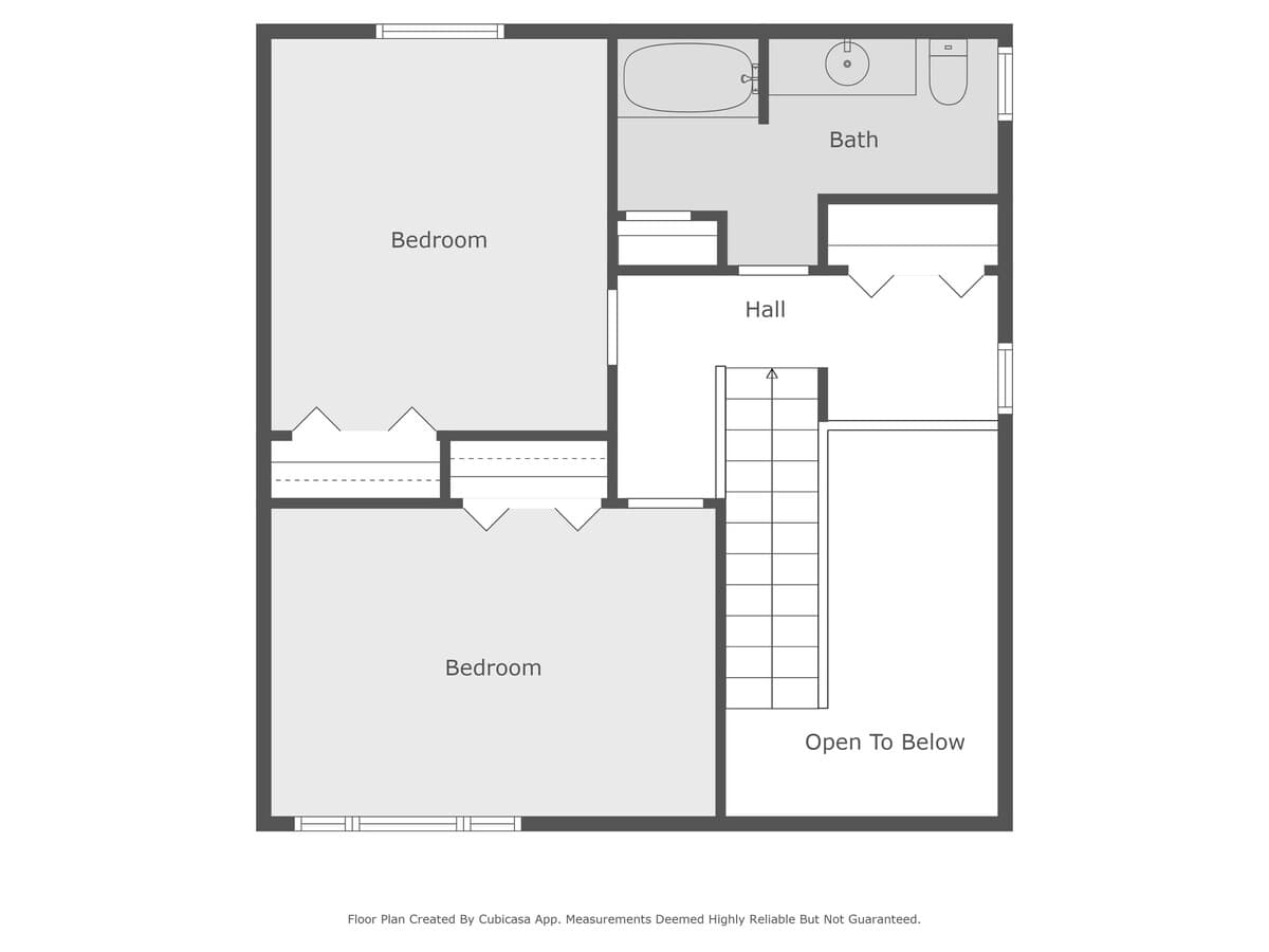 A detailed floor plan of the upper level, showing the arrangement of two bedrooms, a full bathroom, and a central hall with stairs leading down to the level below, featuring an 'Open To Below' area.