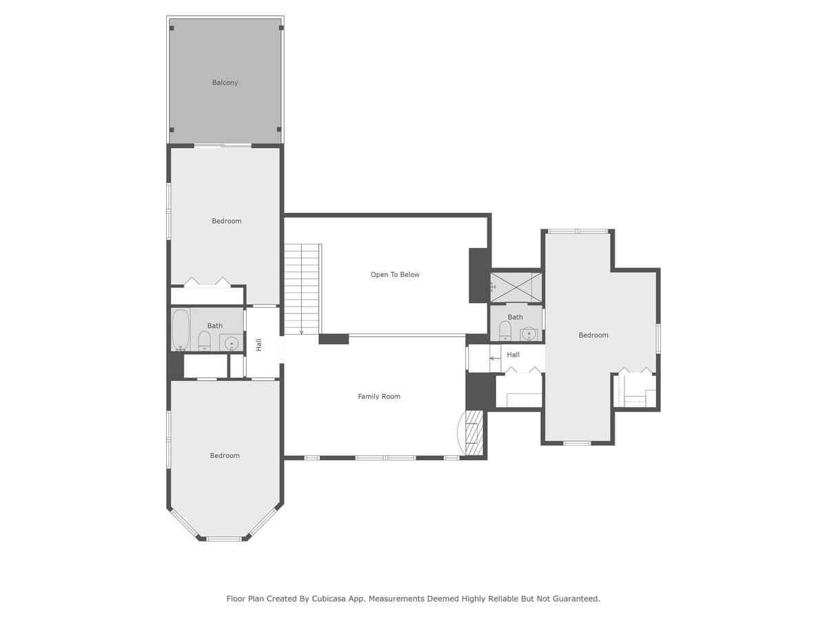 Detailed floor plan of the upper level, featuring multiple bedrooms, bathrooms, a family room, a private balcony, and an "Open To Below" area, indicating a two-story ceiling in a lower living space.
