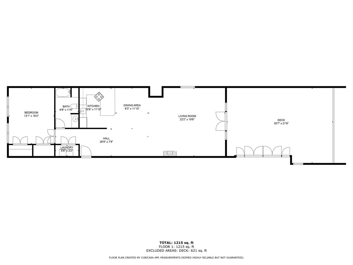 A detailed black and white floor plan illustrates the 1215 sq ft loft layout, featuring a bedroom, bathroom, kitchen, dining area, living room, laundry, hall, and a spacious deck, with dimensions provided for each space.