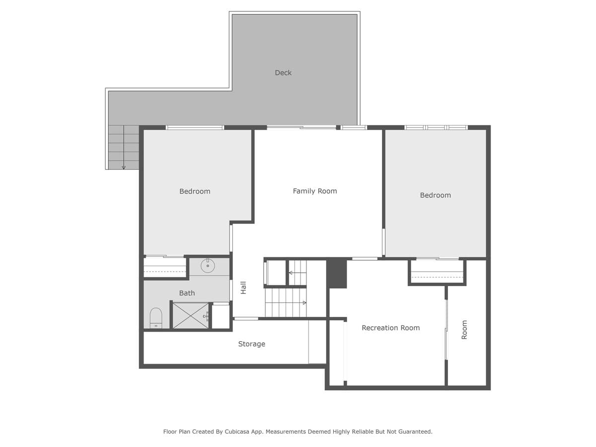A floor plan for the second level, detailing the arrangement of two bedrooms, a family room, a bathroom, storage space, and a recreation room, with an adjacent outdoor deck.