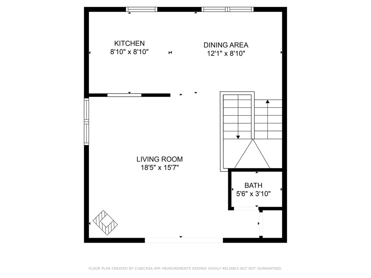 A black and white floor plan illustrating the lower level layout, detailing a kitchen, dining area, living room, and one bathroom, along with stairs and room dimensions.