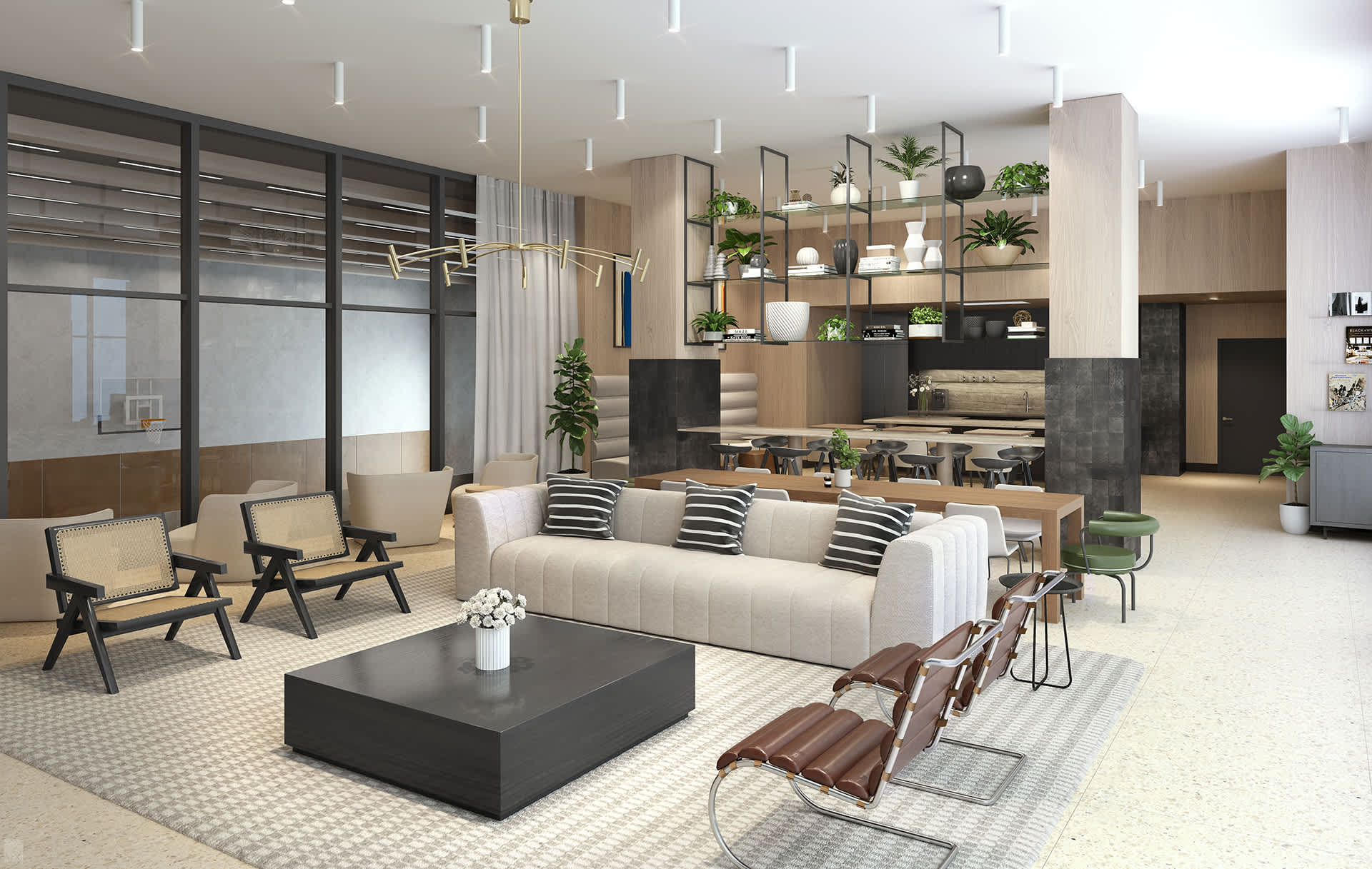 Spacious and stylish common lounge area featuring a long cream sofa with striped pillows, various armchairs, a large dark coffee table, and a dining/work area with integrated shelving and plants in the background.