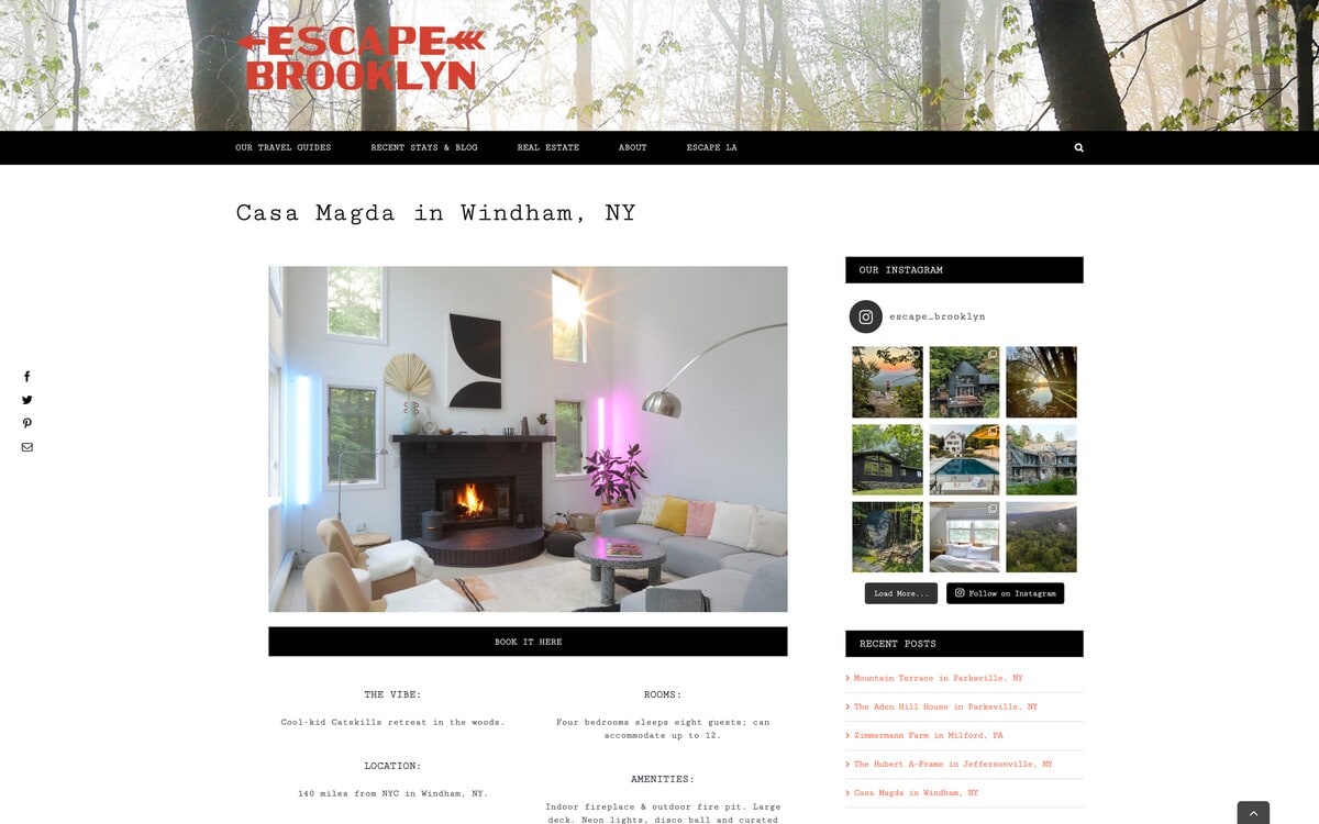 Website screenshot showcasing a modern living room with a black brick fireplace, high ceilings, minimalist decor, a grey sectional sofa, and a vibrant pink accent light.