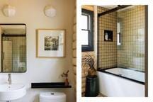 A modern bathroom featuring a white floating sink, black-framed mirror, and a toilet. The shower area has a white bathtub with a black-framed glass screen and small square tiled walls, including a built-in niche.