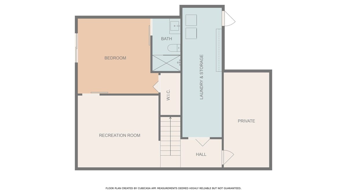 Floor plan of the lower level, featuring a recreation room, a bedroom, a bathroom, and a laundry and storage area. Stairs lead down to this level, indicating a multi-story property.