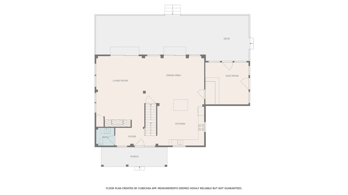 Floor plan illustrating the main level layout, including a living room, dining area, kitchen, mudroom, foyer, and a small bathroom. A deck extends from the back of the house, indicating outdoor space.