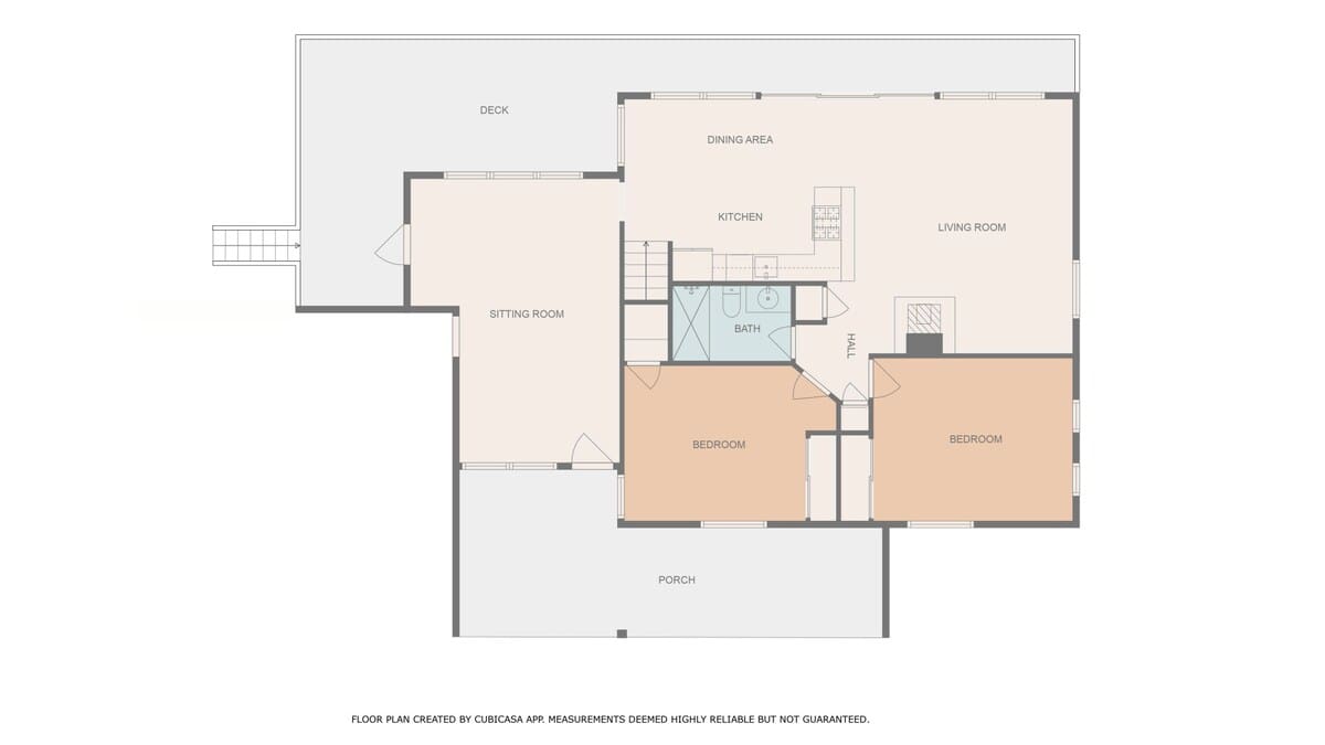 Detailed floor plan of the second level, featuring two bedrooms, a bathroom, kitchen, living room, dining area, sitting room, and outdoor deck and porch areas.