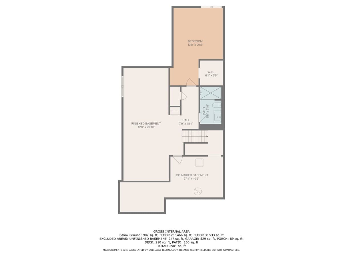 A detailed floor plan for the first floor (basement level) of a house, featuring a finished basement area, an unfinished basement, a bedroom with a walk-in closet, a hall, and a full bathroom.
