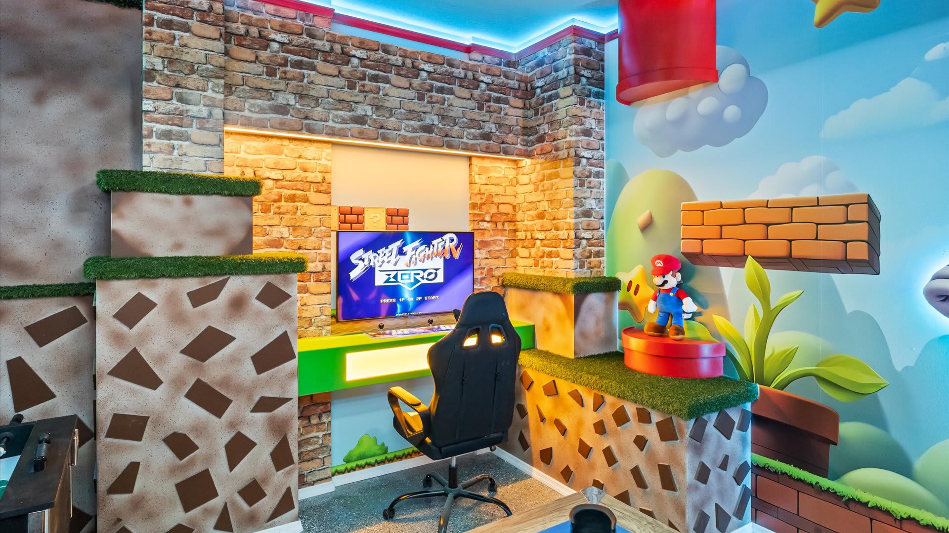 Another view of the Super Mario Bros.-themed game room, showcasing a single gaming station with a monitor displaying "Street Fighter Zero" and a black gaming chair. The room features brick-patterned walls and 3D Mario-themed elements.
