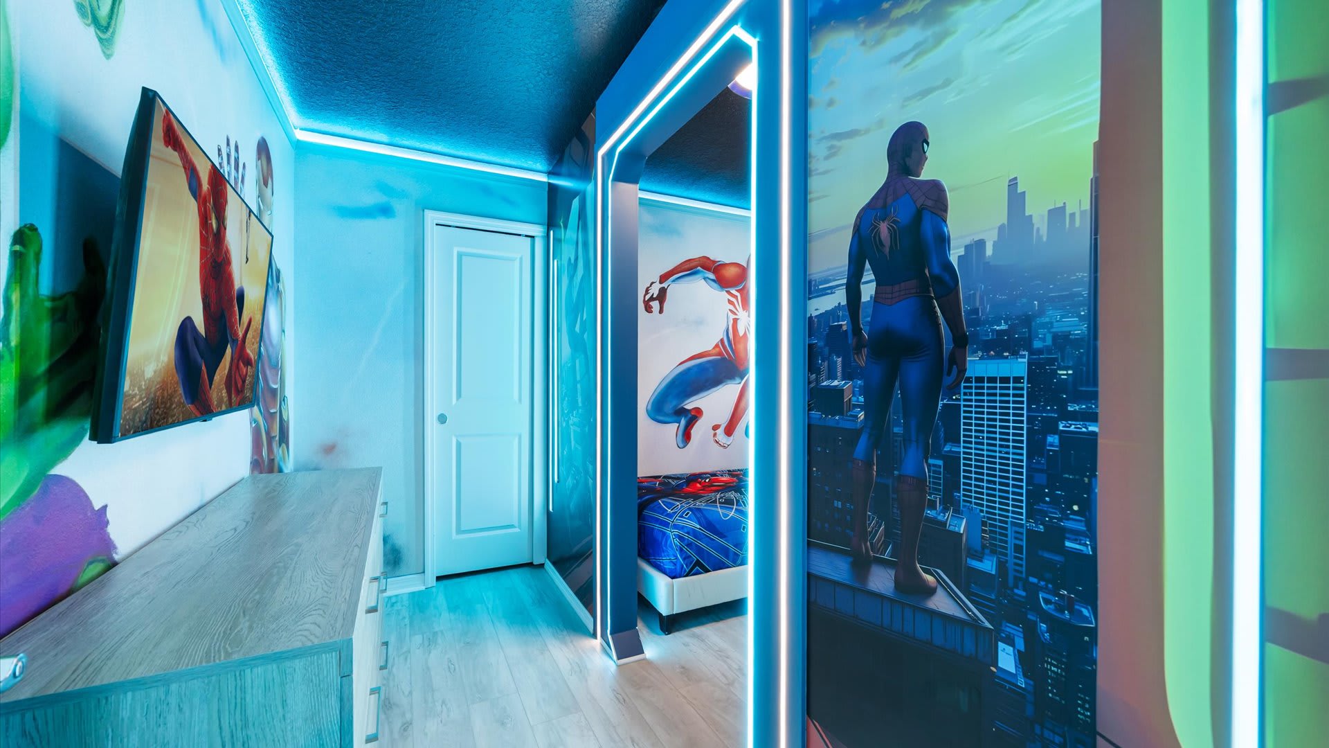 Dynamic "Spiderman" themed bedroom with vibrant wall murals, blue LED strip lighting, and an illuminated archway leading to another sleeping area.