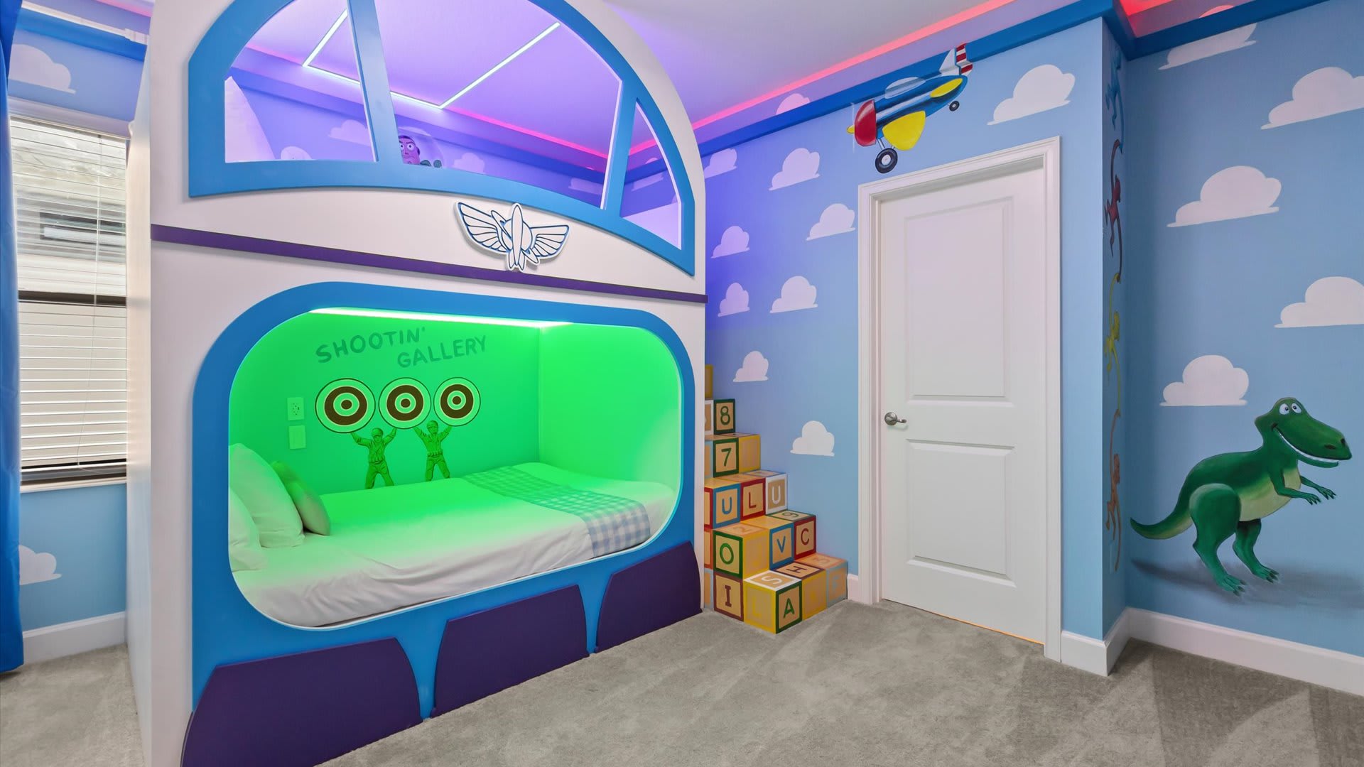 A 'Toy Story' themed bedroom features a custom-built bunk bed designed like Buzz Lightyear's spaceship, with illuminated interiors. The walls are painted with clouds and characters like Rex, complemented by decorative alphabet blocks.