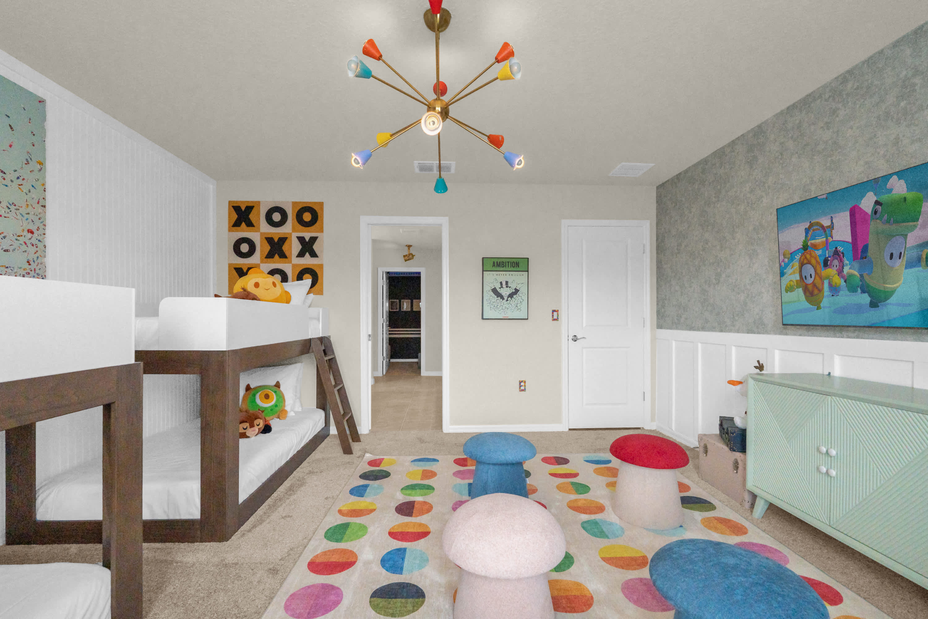 Another view of the kids' bunk bed room, showing a large "XOXO" wall art, a mint green dresser, and a variety of plush toys on the beds, enhancing the playful and child-friendly theme.