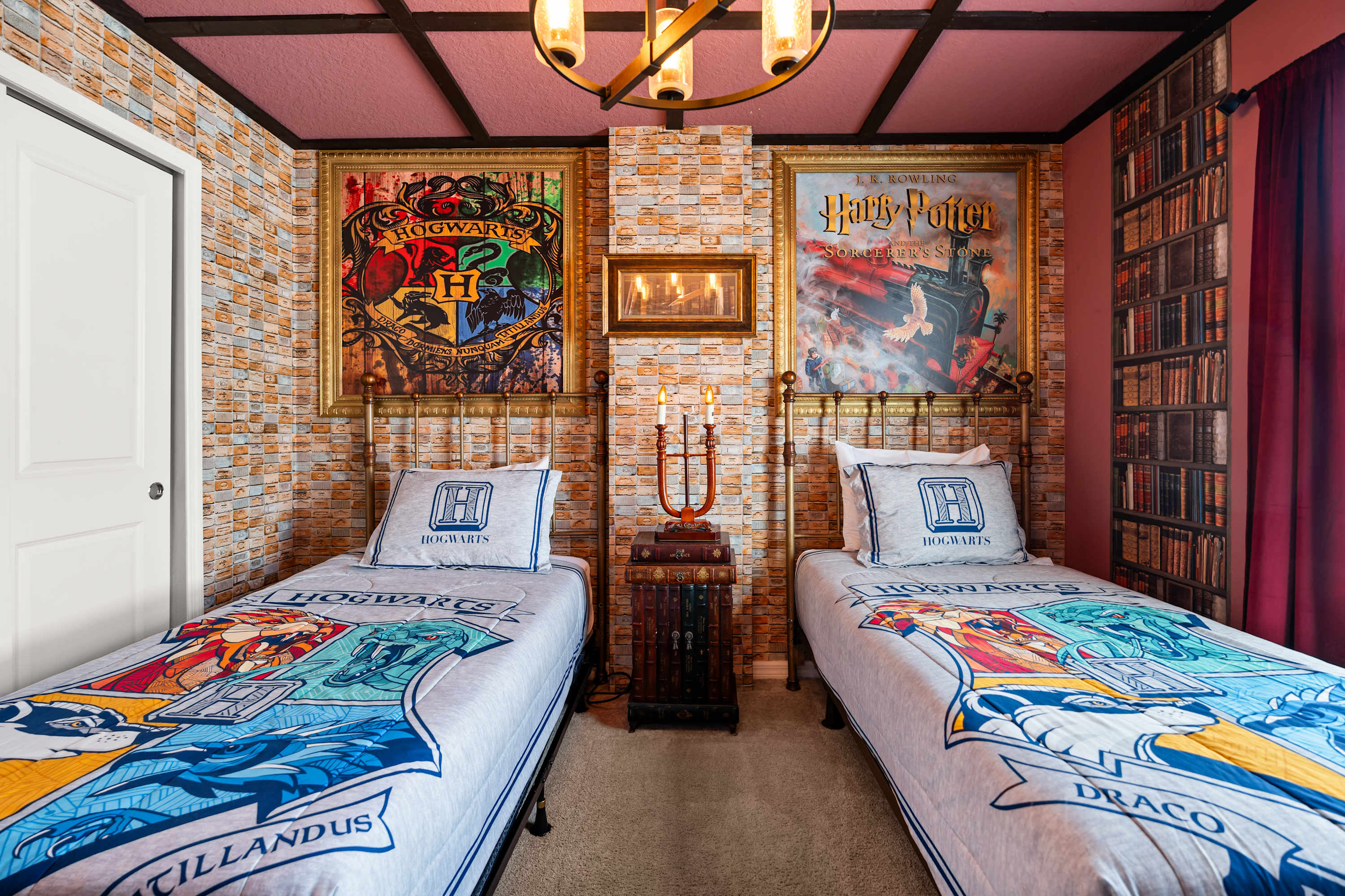 A closer view of the "Harry Potter" themed bedroom, highlighting two twin beds with themed bedding, a brick-patterned accent wall, and framed artwork. A closed white door is visible on the left.