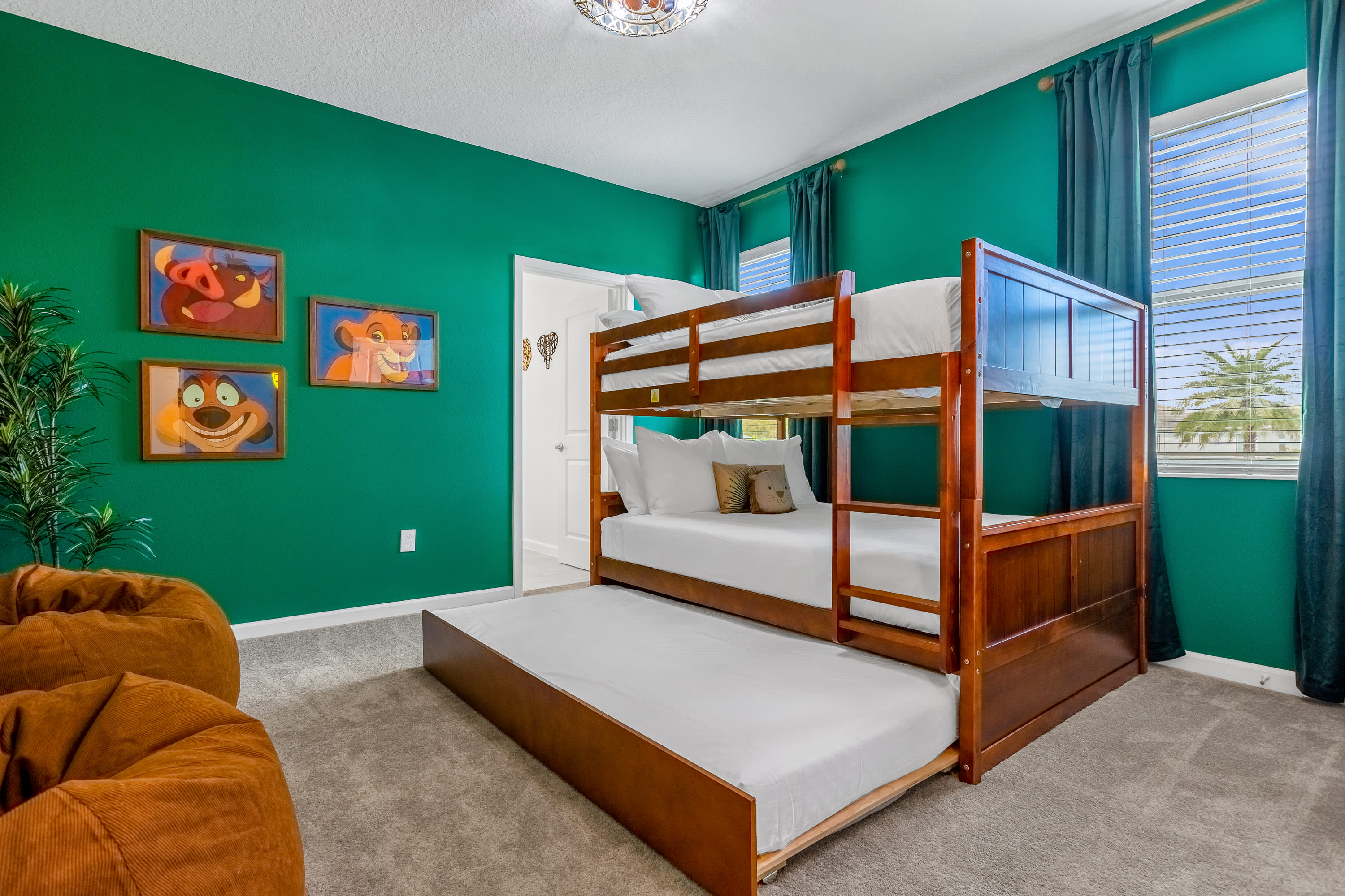 A lively "Lion King" themed bedroom with bright green walls, a sturdy wooden bunk bed featuring a trundle, and two orange bean bag chairs, creating a fun and adventurous space.