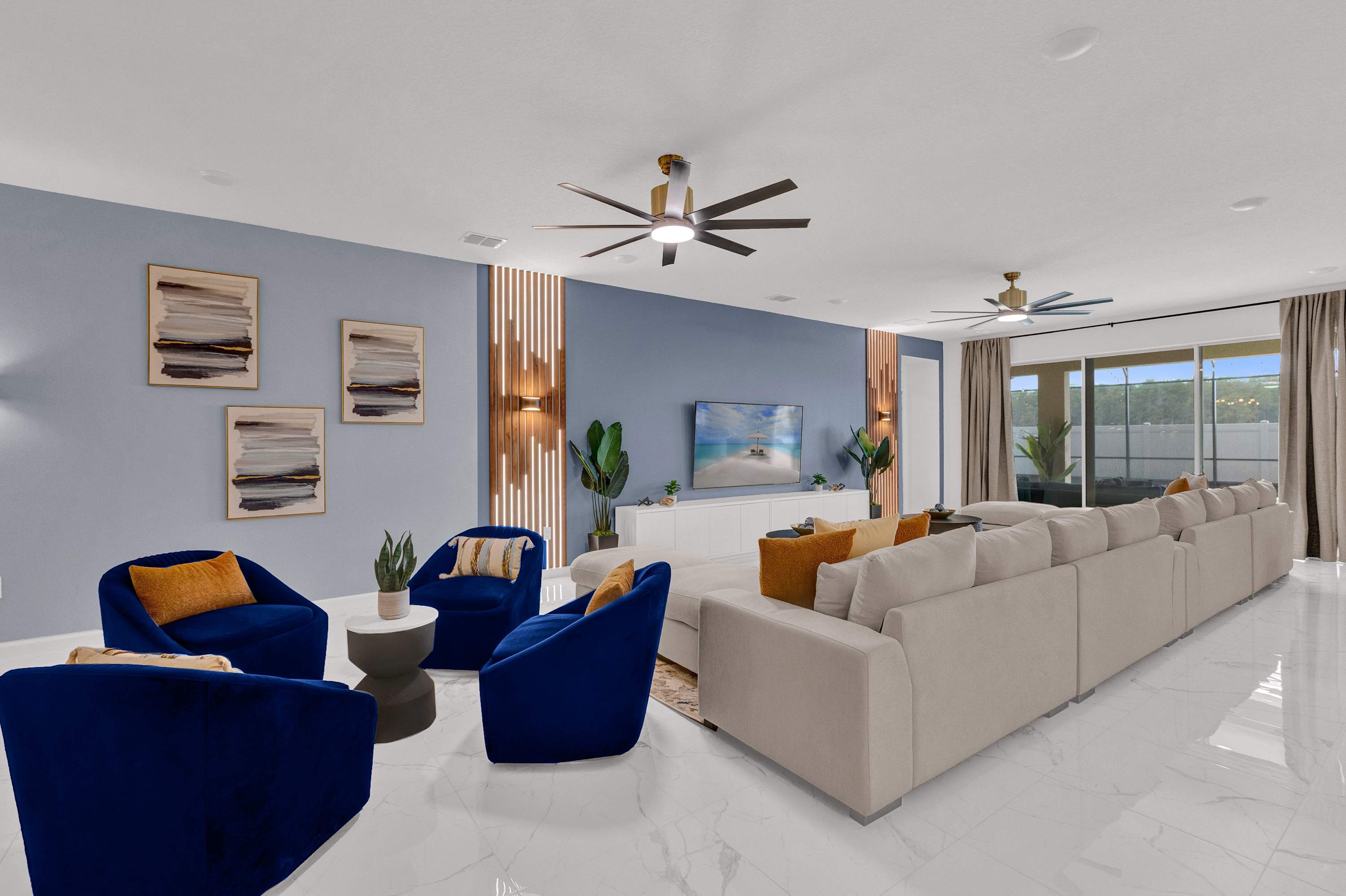 A stylish living room seating area featuring four plush blue armchairs with yellow accent pillows, a modern white console with a large TV, and decorative wall art against a light blue wall.