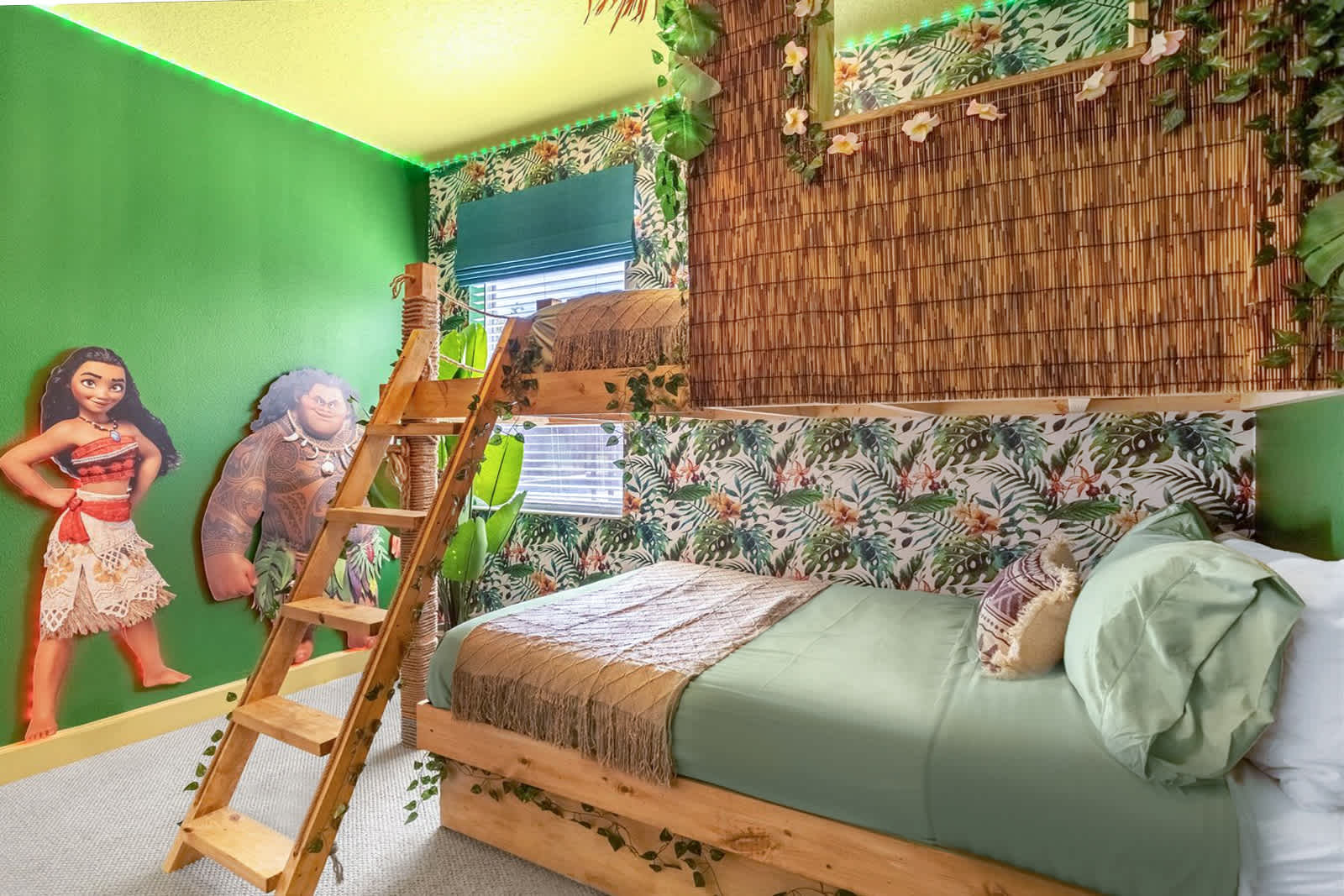 Vibrant Moana-themed bedroom featuring a rustic wooden bunk bed with a single bottom mattress, bright green walls, tropical leaf wallpaper, and character cutouts of Moana and Maui.