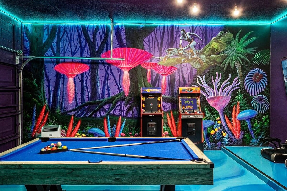 A detailed view of the game room highlights the blue-felt pool table with cues and balls, set against a vibrant, fantastical mural depicting glowing mushrooms and alien-like flora. Neon strip lighting along the ceiling adds to the immersive atmosphere.