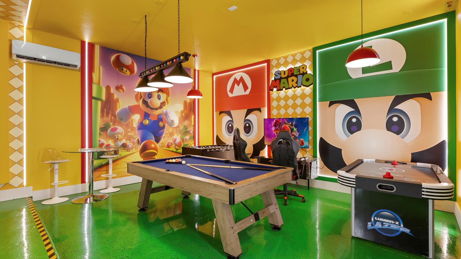 Dynamic Super Mario-themed game room with a pool table, foosball, and dedicated gaming stations featuring large character murals of Mario and Luigi, all on a bright green floor.