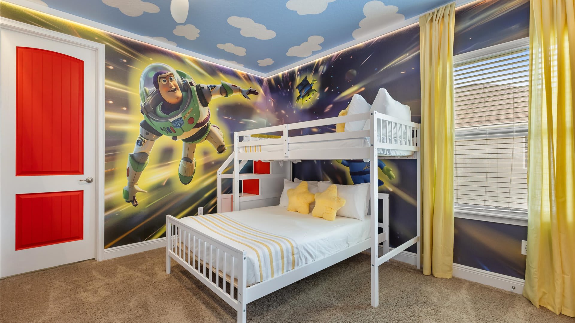 A vibrant Toy Story themed bedroom featuring a large Buzz Lightyear mural on one wall, a white bunk bed with yellow star pillows, and a ceiling painted with clouds.
