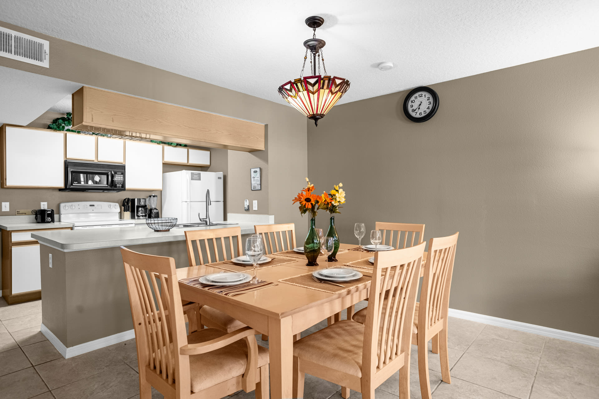 An alternative view of the kitchen and dining area, highlighting the breakfast bar separating the two spaces and the overall open-concept layout.