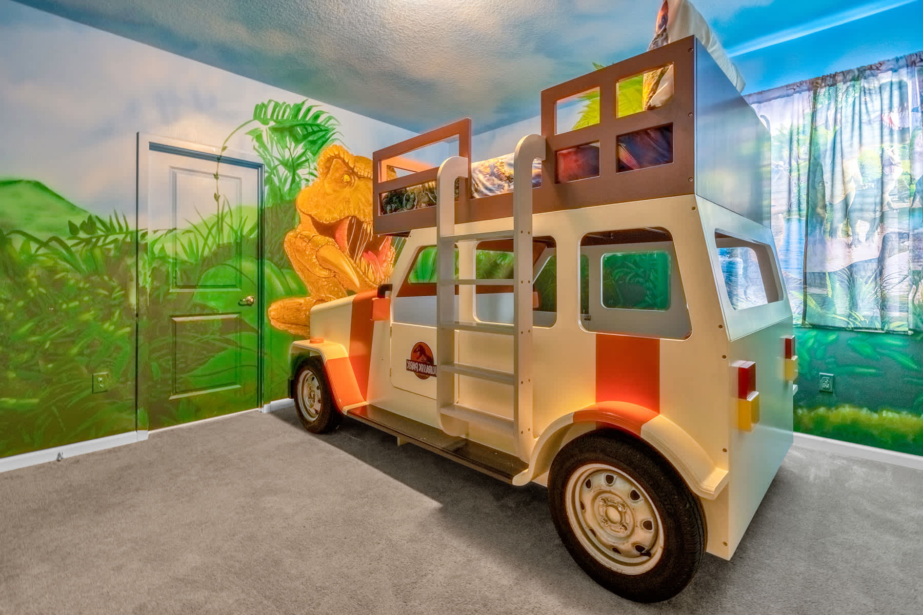Another angle of the Jurassic Park-themed bedroom, highlighting the rear of the safari vehicle bunk bed and the detailed jungle wall murals, including a door blending into the scenery.
